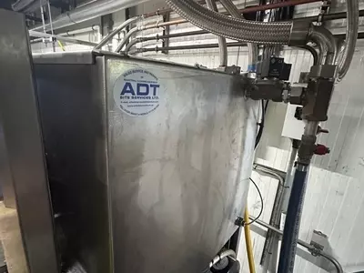 Rear view of custom stainless steel replacement tank installed on a Nilfisk Delta Booster multi-pump pressure washer system.